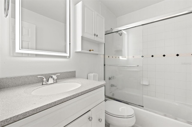 full bathroom with vanity, toilet, and bath / shower combo with glass door