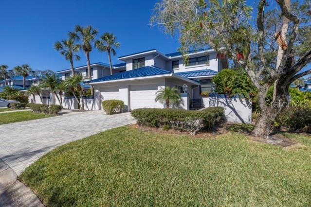 view of front of house featuring a garage and a front yard