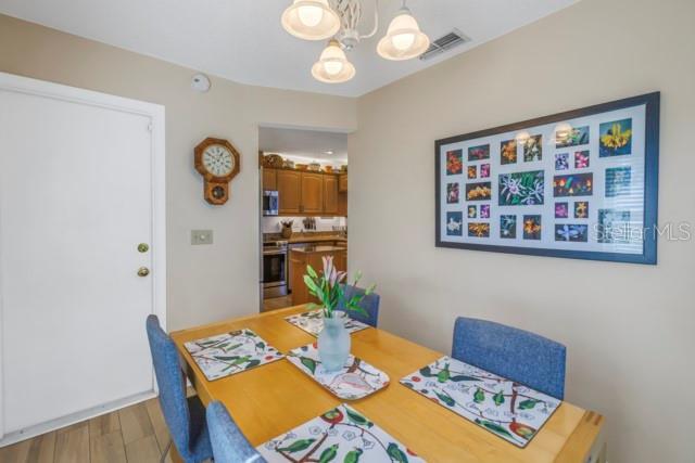 dining area with hardwood / wood-style flooring and a chandelier