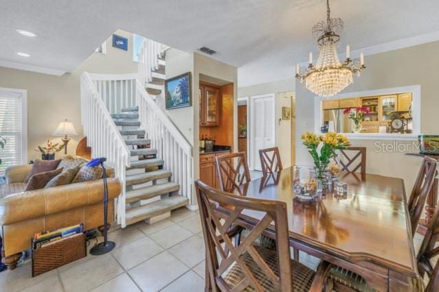 tiled dining space with an inviting chandelier