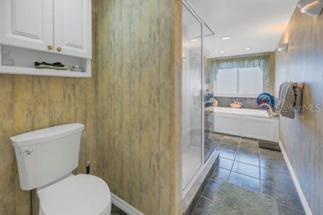 bathroom featuring tile patterned flooring, an enclosed shower, and toilet