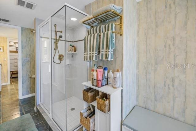 bathroom featuring tile patterned floors and a shower with shower door