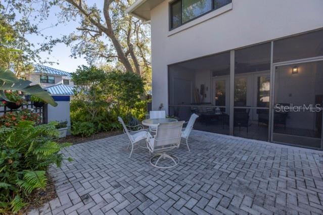 view of patio / terrace featuring a sunroom