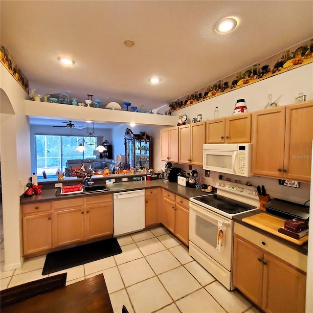 kitchen featuring white appliances, ceiling fan, light tile patterned floors, decorative light fixtures, and kitchen peninsula