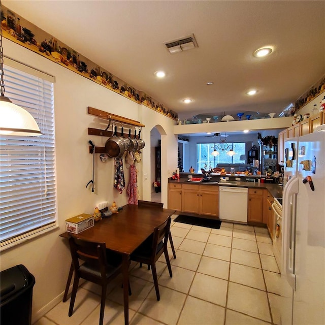 kitchen featuring ceiling fan, hanging light fixtures, kitchen peninsula, white appliances, and light tile patterned flooring