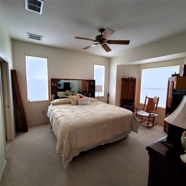 bedroom featuring ceiling fan and light carpet