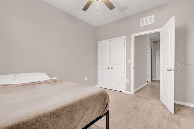 carpeted bedroom featuring ceiling fan and a closet