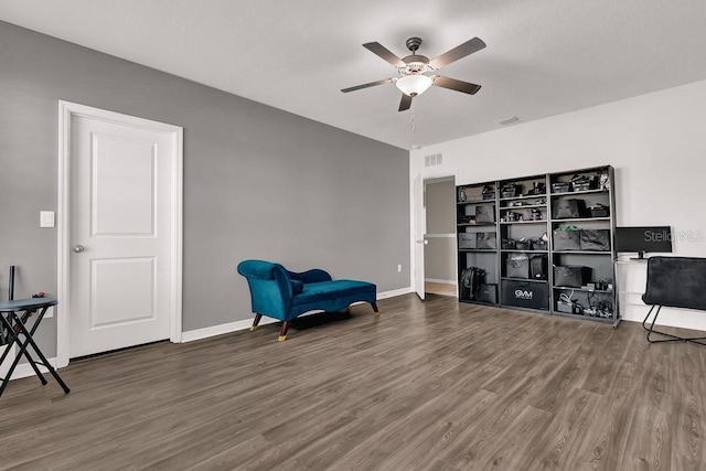 living area with dark hardwood / wood-style floors and ceiling fan