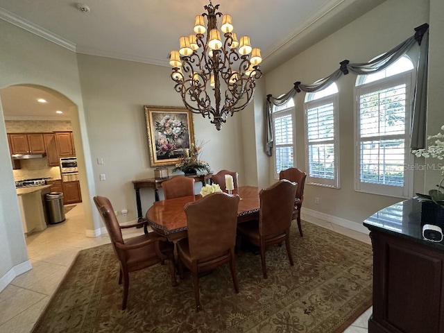 tiled dining space with a chandelier and crown molding