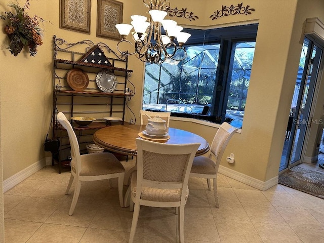 tiled dining room featuring an inviting chandelier