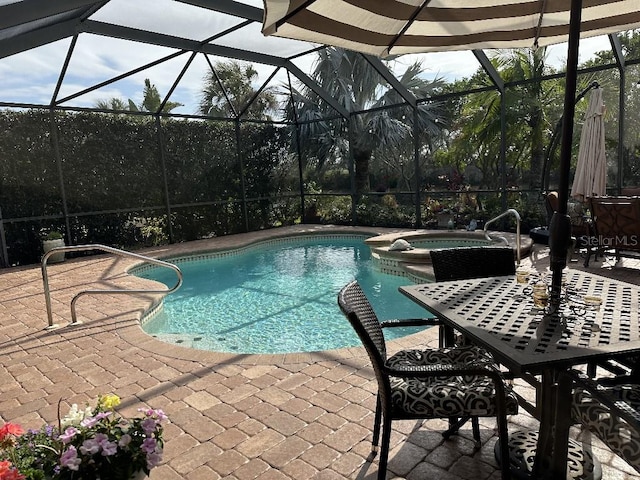 view of swimming pool with glass enclosure, an in ground hot tub, and a patio