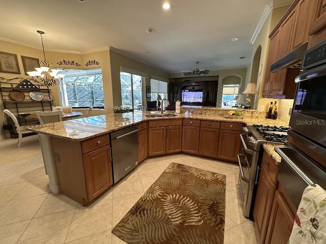 kitchen with a healthy amount of sunlight, range with two ovens, dishwasher, a sink, and a chandelier