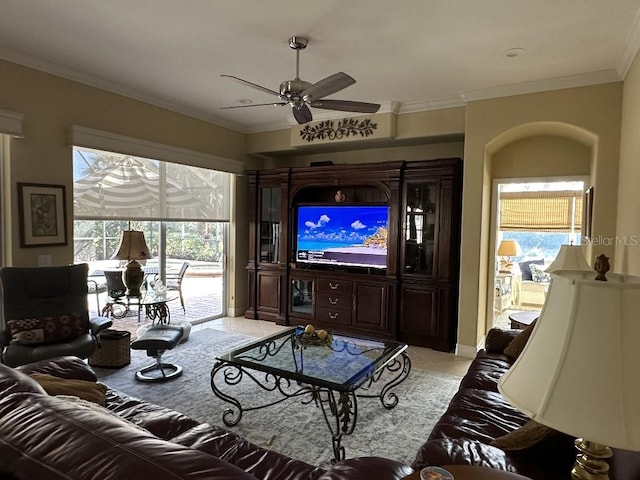 living room with light tile patterned flooring, ceiling fan, and ornamental molding