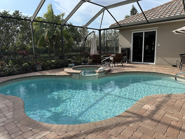 view of swimming pool featuring a lanai, a patio, and a pool with connected hot tub