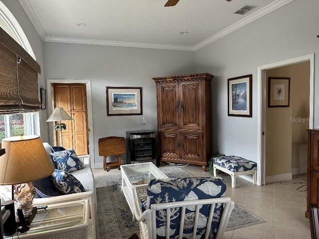 interior space with a ceiling fan, visible vents, crown molding, light tile patterned floors, and baseboards