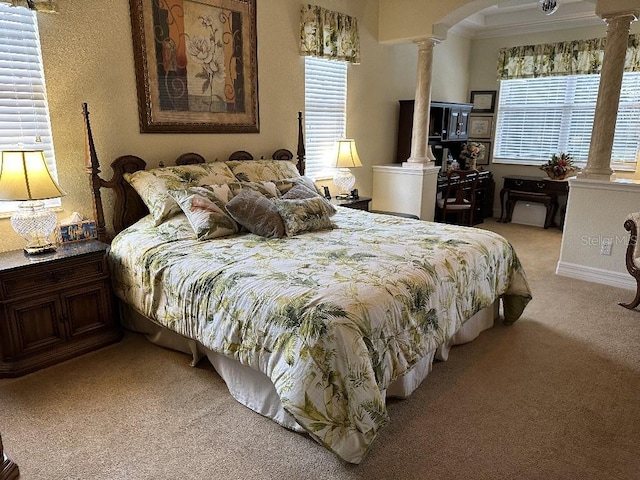 bedroom featuring ornate columns, arched walkways, and light carpet