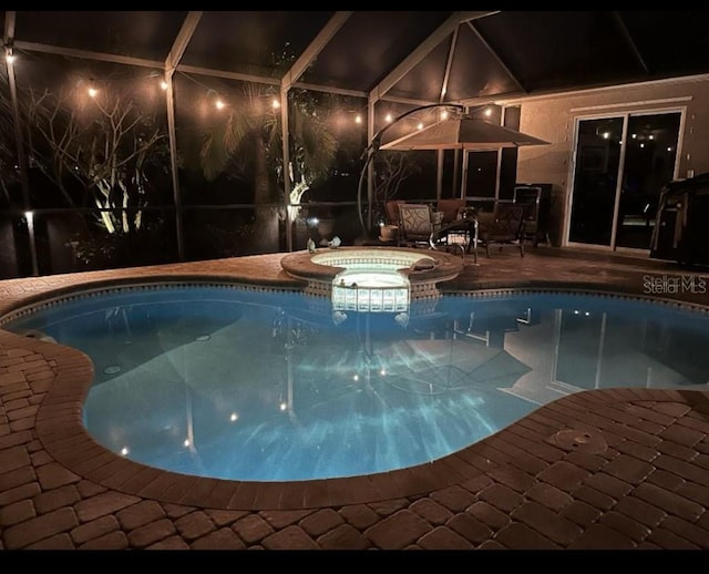 10626 Restoration Ter, Bradenton, FL 34212 - view of swimming pool featuring glass enclosure, a pool with connected hot tub, and a patio