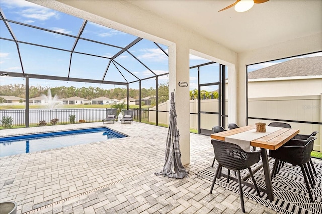 view of swimming pool featuring a lanai, a patio area, and ceiling fan