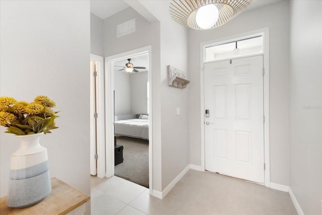 entryway featuring ceiling fan and light tile patterned floors