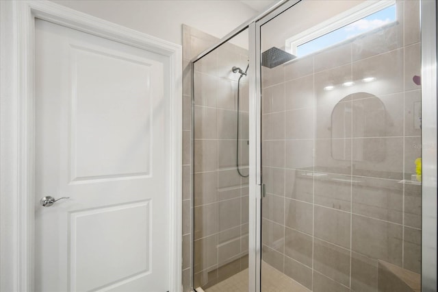 bathroom featuring a shower with shower door