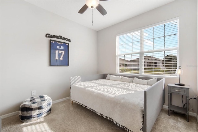 bedroom featuring multiple windows, light colored carpet, and ceiling fan