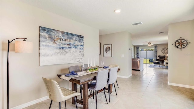 dining area featuring light tile patterned floors and ceiling fan