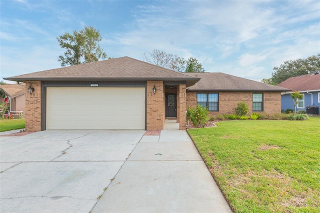 ranch-style home featuring a front lawn, central AC unit, and a garage