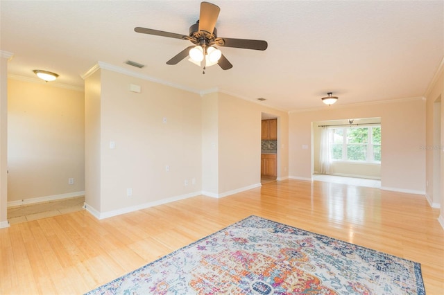 empty room with light wood-type flooring, ceiling fan, and ornamental molding