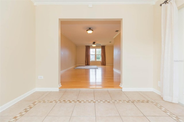 interior space with light tile patterned floors and ornamental molding