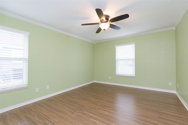 spare room featuring dark hardwood / wood-style flooring, ceiling fan, and crown molding