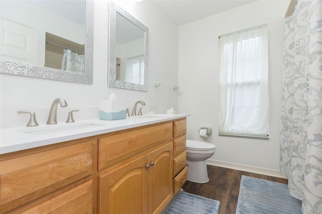 bathroom featuring hardwood / wood-style floors, vanity, and toilet