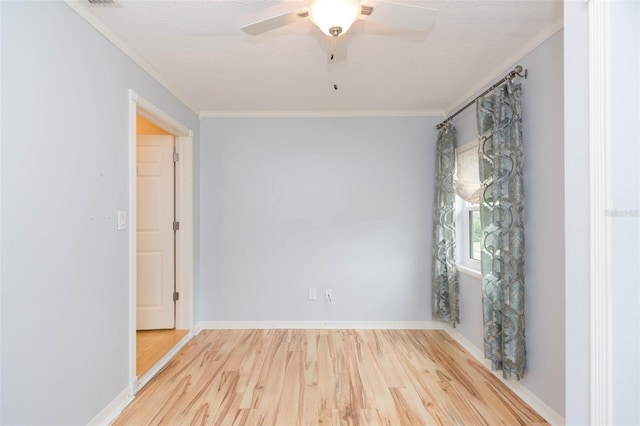 empty room with ceiling fan, wood-type flooring, and crown molding