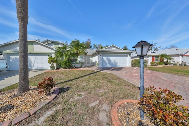 single story home with a front yard and a garage