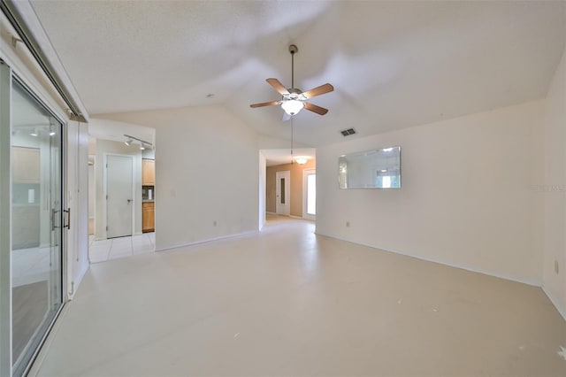 spare room with ceiling fan, a textured ceiling, and vaulted ceiling