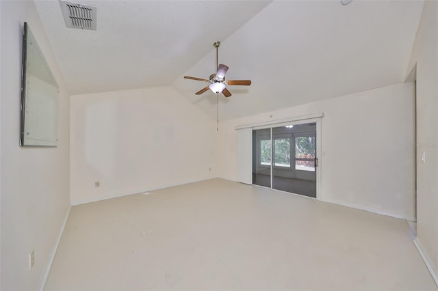 empty room featuring ceiling fan, lofted ceiling, and a textured ceiling