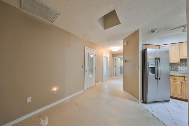 hall with a textured ceiling