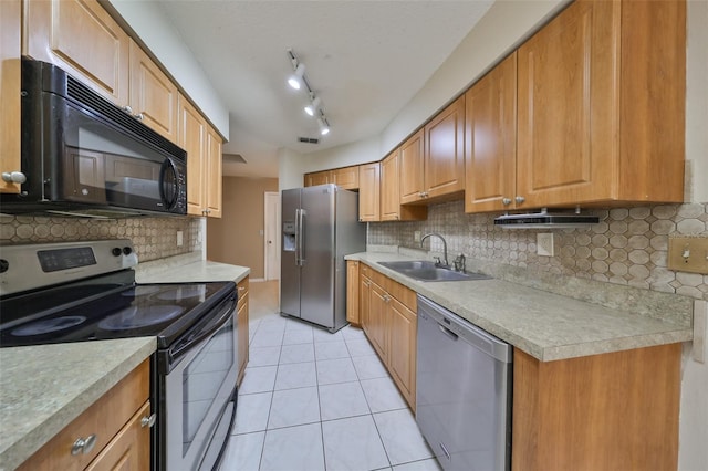 kitchen featuring sink, light tile patterned floors, stainless steel appliances, and tasteful backsplash