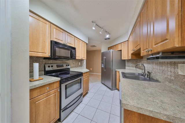 kitchen with decorative backsplash, light tile patterned floors, stainless steel appliances, and sink