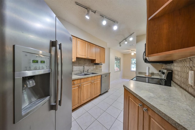 kitchen featuring sink, decorative backsplash, ceiling fan, light tile patterned floors, and appliances with stainless steel finishes