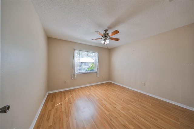 unfurnished room with a textured ceiling, light hardwood / wood-style floors, and ceiling fan