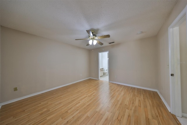 unfurnished room with ceiling fan, light hardwood / wood-style floors, and a textured ceiling