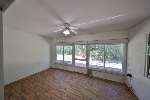 unfurnished room with ceiling fan and dark hardwood / wood-style floors