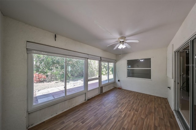 unfurnished sunroom featuring ceiling fan