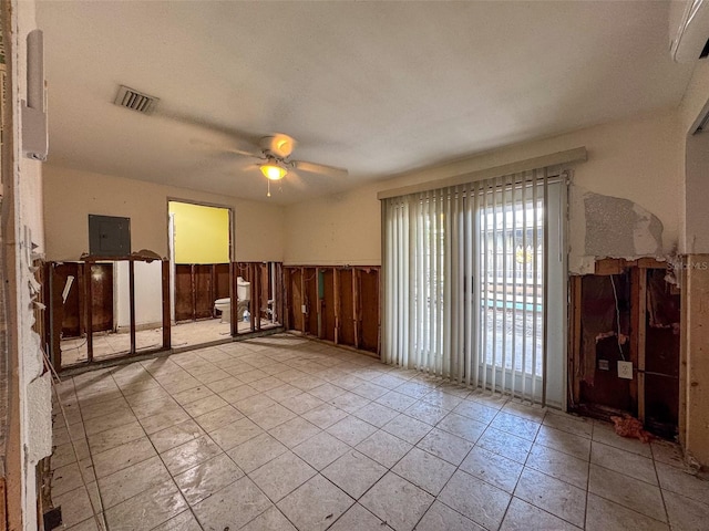 empty room featuring electric panel and ceiling fan