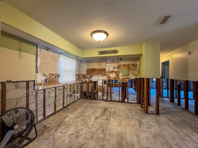 miscellaneous room with a textured ceiling