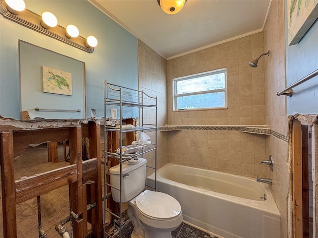 bathroom with tiled shower / bath combo, toilet, and crown molding