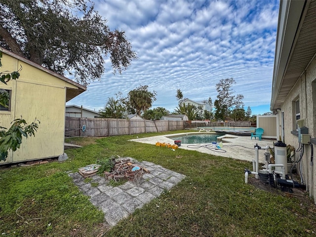 view of yard featuring a fenced in pool and a patio area