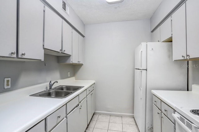 kitchen with white cabinetry, sink, a textured ceiling, light tile patterned flooring, and range