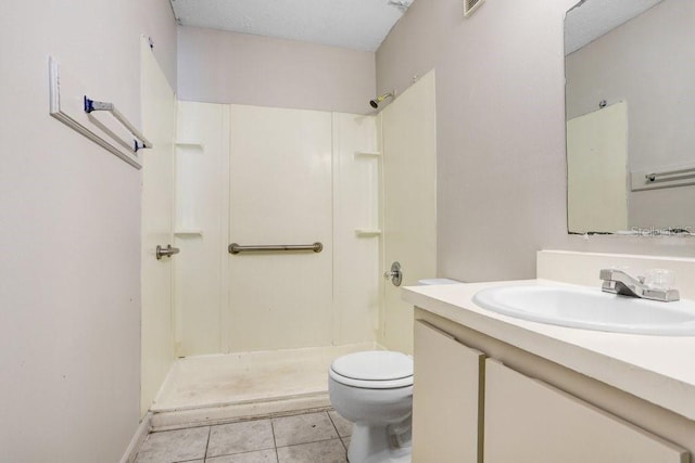 bathroom featuring tile patterned floors, a shower, vanity, and toilet