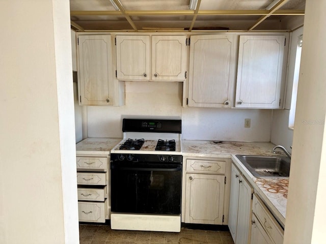 kitchen with sink and white range with gas cooktop